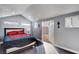 Spacious bedroom with light grey walls and dark wood-look floors, access to bathroom, and recessed lighting at 563 Moon Chase St, Las Vegas, NV 89110