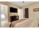 Bedroom showcases tiled flooring, a dresser, and a doorway leading to the bathroom at 563 Moon Chase St, Las Vegas, NV 89110