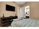 Cozy bedroom features an ensuite bathroom and a television at 563 Moon Chase St, Las Vegas, NV 89110