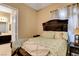 Well-lit bedroom features sliding closet doors, a decorative headboard, and access to the ensuite bathroom at 563 Moon Chase St, Las Vegas, NV 89110