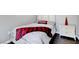 Simple bedroom features stylish accent pillow, nightstand, and hardwood floors at 563 Moon Chase St, Las Vegas, NV 89110