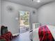 Bedroom featuring neutral walls, stylish lighting, and a view to the backyard pool at 563 Moon Chase St, Las Vegas, NV 89110