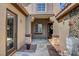Warm and inviting gated courtyard featuring a stone walkway and a lovely open porch and front door at 563 Moon Chase St, Las Vegas, NV 89110