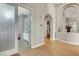 Bright hallway leading to a bedroom and an entryway, featuring tile floors and an arched ceiling at 563 Moon Chase St, Las Vegas, NV 89110