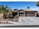 Beautiful single-story home featuring a desert landscape, tile roof, and a spacious three-car garage at 563 Moon Chase St, Las Vegas, NV 89110