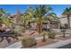 Charming single-story home with desert landscaping, tile roof, long driveway, and a three-car garage at 563 Moon Chase St, Las Vegas, NV 89110