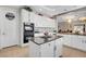 Spacious kitchen features an island, granite countertops, stainless oven, bright cabinets, and a laundry room access at 563 Moon Chase St, Las Vegas, NV 89110
