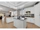 Open kitchen with an island, granite countertops, tile flooring, stainless appliances, and access to living room at 563 Moon Chase St, Las Vegas, NV 89110