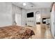 Bright main bedroom boasts tile flooring, neutral walls, TV, fireplace, and access to the ensuite bathroom at 563 Moon Chase St, Las Vegas, NV 89110