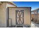 Exterior view of storage shed in backyard, next to a gate at 563 Moon Chase St, Las Vegas, NV 89110
