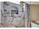 Close up of the marble tiled walk-in shower with built in niche at 563 Moon Chase St, Las Vegas, NV 89110