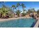 Stunning swimming pool and rock waterfall feature surrounded by lush tropical landscaping for privacy at 563 Moon Chase St, Las Vegas, NV 89110