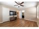 Bedroom featuring wood floors, a ceiling fan, and an en-suite bathroom at 6255 W Arby Ave # 183, Las Vegas, NV 89118