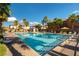 Resort-style community pool with palm trees and lounge chairs at 6255 W Arby Ave # 183, Las Vegas, NV 89118