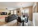 Open-concept dining area featuring a modern glass table, leather sofa, and adjacent living room at 6255 W Arby Ave # 183, Las Vegas, NV 89118