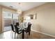 Bright dining room with a glass table, stylish chairs, and sliding glass doors to a patio at 6255 W Arby Ave # 183, Las Vegas, NV 89118