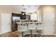 Modern kitchen features stainless steel appliances, sleek black cabinetry, and a breakfast bar with seating at 6255 W Arby Ave # 183, Las Vegas, NV 89118