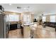 Open-concept kitchen flowing into the living room with stainless steel appliances at 6255 W Arby Ave # 183, Las Vegas, NV 89118