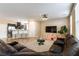 Open living room area with tile flooring, modern furniture, and adjacent kitchen at 6255 W Arby Ave # 183, Las Vegas, NV 89118