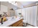 Well-lit bathroom with white vanity, toilet, and a white shower curtain at 653 Freeburg Pl, Las Vegas, NV 89123