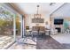 Cozy dining area with backyard access is open to a living room with fireplace at 653 Freeburg Pl, Las Vegas, NV 89123
