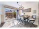 Bright dining area features a modern chandelier and sliding doors to the landscaped backyard at 653 Freeburg Pl, Las Vegas, NV 89123