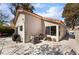 The back of the house features stucco siding, a terracotta roof, and a concrete patio at 653 Freeburg Pl, Las Vegas, NV 89123