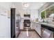 Well-lit kitchen featuring stainless steel appliances and white cabinetry at 653 Freeburg Pl, Las Vegas, NV 89123
