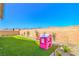 This backyard is Gathering-friendly with green turf, hardscape accents, and a pink playhouse and slide set at 6593 Corsari Ridge St, Las Vegas, NV 89166