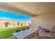 Covered patio boasts backyard views with green turf and a playhouse in a fully enclosed yard at 6593 Corsari Ridge St, Las Vegas, NV 89166