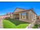 A spacious backyard featuring green turf, a covered patio, and plenty of room for entertaining friends and Gathering at 6593 Corsari Ridge St, Las Vegas, NV 89166
