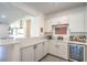 View of a bar area with white cabinets, light countertops, and wine fridge at 6593 Corsari Ridge St, Las Vegas, NV 89166