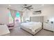 Bedroom featuring a large window, ceiling fan, and neutral decor at 6593 Corsari Ridge St, Las Vegas, NV 89166