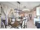 Dining area with access to patio, view of modern kitchen and living spaces at 6593 Corsari Ridge St, Las Vegas, NV 89166