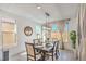 Bright dining room with modern light fixture, neutral decor and natural light at 6593 Corsari Ridge St, Las Vegas, NV 89166