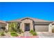 Charming single-story home featuring stone accents, a tile roof, and well-manicured landscaping at 6593 Corsari Ridge St, Las Vegas, NV 89166