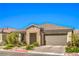 Beautiful single-story home featuring stone accents, tile roofing, paver driveway, and mature landscaping at 6593 Corsari Ridge St, Las Vegas, NV 89166