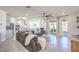 Bright, open-concept living room with modern furnishings, tile floors, and ample natural light at 6593 Corsari Ridge St, Las Vegas, NV 89166