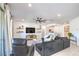 Spacious living room with comfortable seating, ceiling fan, and access to kitchen and other living spaces at 6593 Corsari Ridge St, Las Vegas, NV 89166