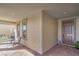Covered porch with tiled flooring, seating, and an attractive entryway door at 6593 Corsari Ridge St, Las Vegas, NV 89166