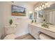 Bright bathroom featuring a stylish vanity, framed mirror and modern light fixture at 725 N Royal Crest Cir # 227, Las Vegas, NV 89169