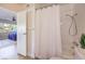 Bathroom featuring a shower-tub combo with white tile and wood-look floors at 725 N Royal Crest Cir # 227, Las Vegas, NV 89169