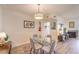 Open dining area showcasing modern light fixture, wet bar, and decorative guitar at 725 N Royal Crest Cir # 227, Las Vegas, NV 89169