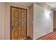 Apartment entrance featuring a wooden door and patterned carpeting at 725 N Royal Crest Cir # 227, Las Vegas, NV 89169