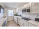 Bright kitchen with white cabinets, stainless steel microwave, and sleek countertops at 725 N Royal Crest Cir # 227, Las Vegas, NV 89169