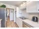 Updated kitchen featuring stainless steel sink, white cabinetry, and modern appliances at 725 N Royal Crest Cir # 227, Las Vegas, NV 89169