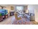 Comfortable living room featuring a stone fireplace, balcony access, and stylish furnishings at 725 N Royal Crest Cir # 227, Las Vegas, NV 89169