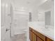 Bright bathroom featuring a vanity with wood cabinets and a tub with shower at 7255 Bold Rock Ave, Las Vegas, NV 89113
