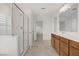 Bright bathroom features a double vanity and walk-in shower at 7255 Bold Rock Ave, Las Vegas, NV 89113