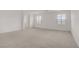 Bedroom with neutral carpet, white walls, and natural light from the windows at 7255 Bold Rock Ave, Las Vegas, NV 89113